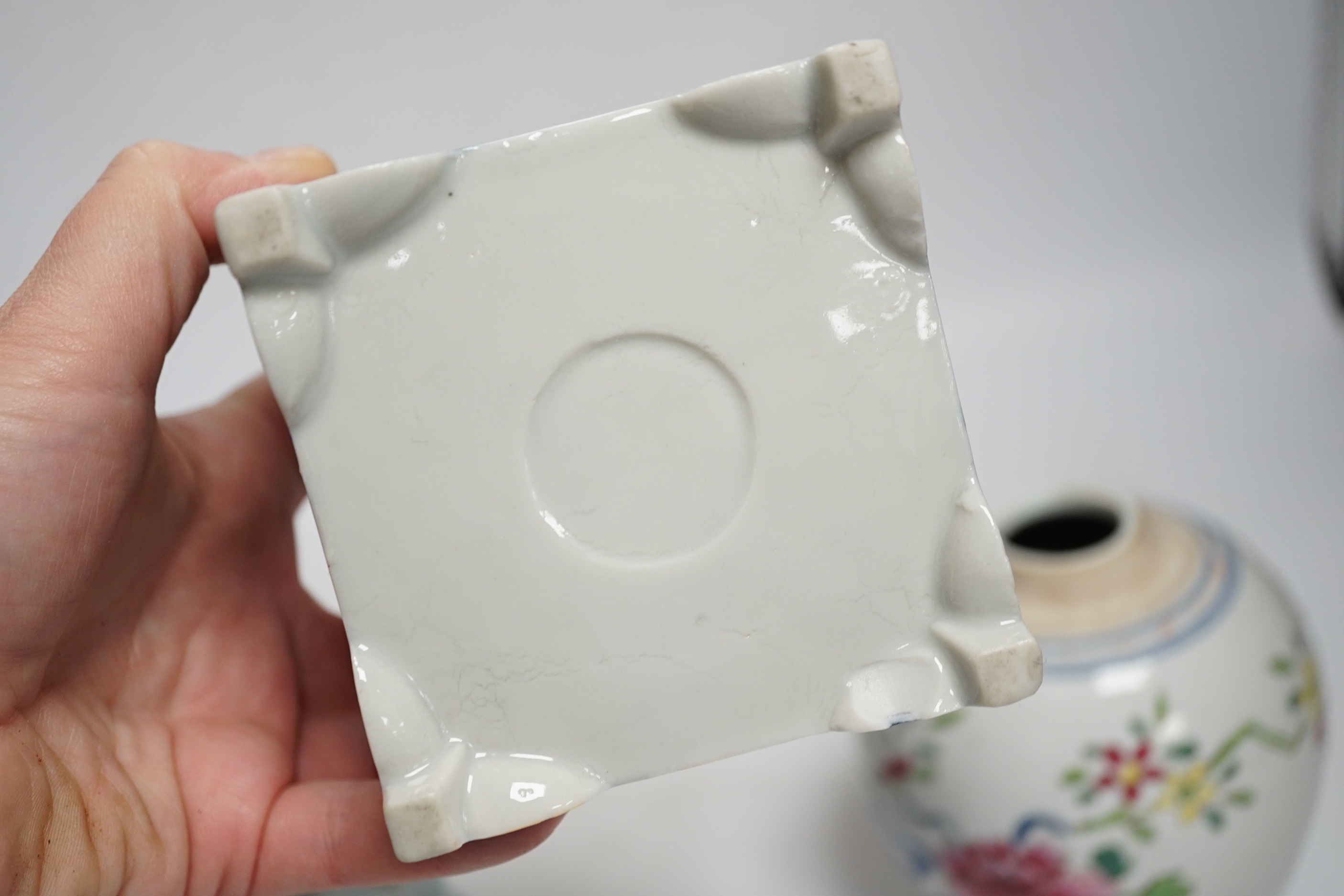A collection of Chinese ceramics including celadon bowl decorated in low relief with fish, famille rose tea bowls and a jar, largest 12cm high